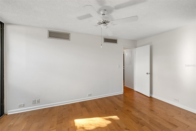 spare room with visible vents, a ceiling fan, and baseboards