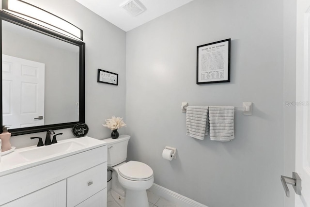 bathroom featuring vanity, baseboards, toilet, and visible vents