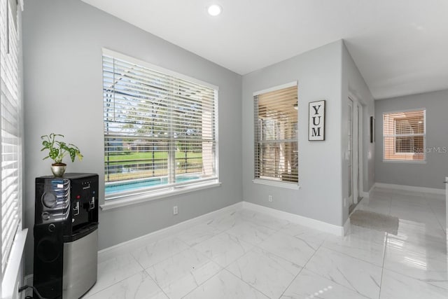 unfurnished room with recessed lighting, baseboards, and marble finish floor