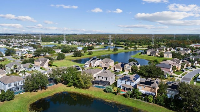 drone / aerial view with a residential view and a water view