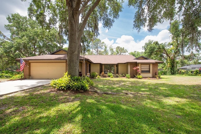 ranch-style home with an attached garage, driveway, and a front yard