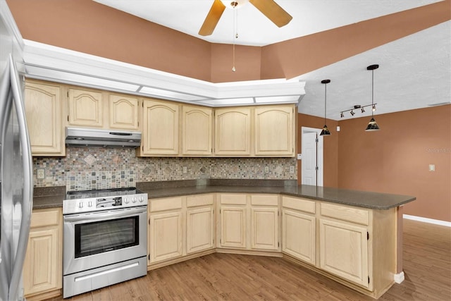 kitchen featuring dark countertops, appliances with stainless steel finishes, light brown cabinets, and under cabinet range hood