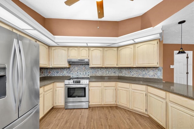kitchen with dark countertops, appliances with stainless steel finishes, and under cabinet range hood