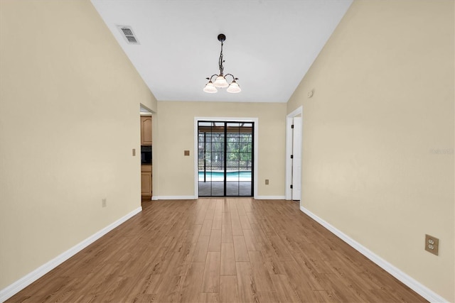 interior space featuring light wood-style floors, baseboards, a chandelier, and visible vents