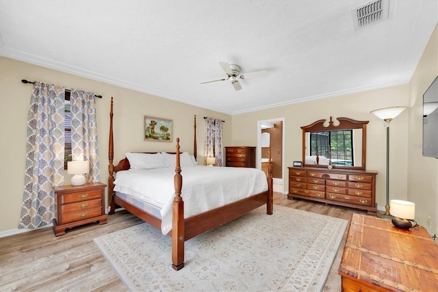 bedroom featuring a ceiling fan, baseboards, visible vents, and wood finished floors