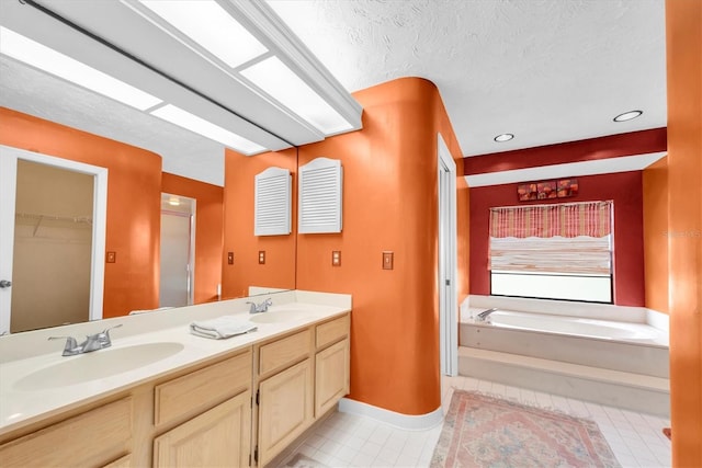 bathroom with double vanity, a sink, a garden tub, and tile patterned flooring