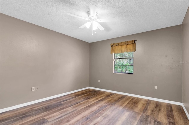 unfurnished room with baseboards, a textured ceiling, ceiling fan, and wood finished floors