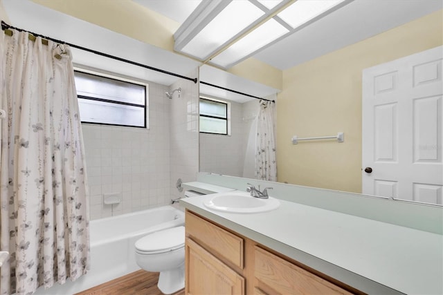 bathroom with vanity, shower / bathtub combination with curtain, toilet, and wood finished floors