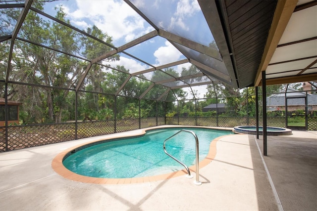 view of pool with a lanai, a patio, and a pool with connected hot tub