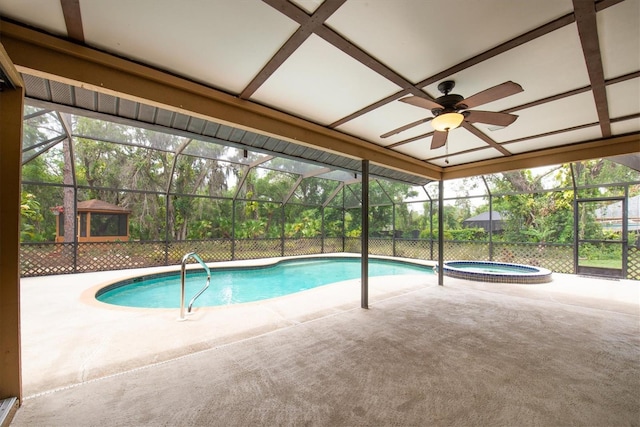 view of pool with a patio, ceiling fan, a pool with connected hot tub, and glass enclosure