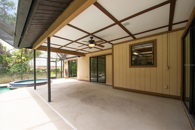 view of patio / terrace featuring ceiling fan, visible vents, a pool with connected hot tub, and glass enclosure