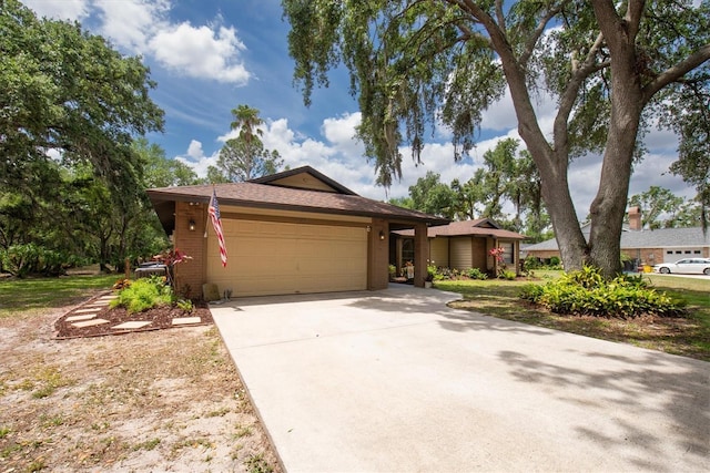 ranch-style home with driveway and a garage