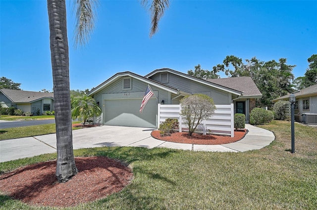 7817 Pine Trace Dr Unit 15, Sarasota, FL 34243 - view of front of house featuring central AC, driveway, an attached garage, and a front yard