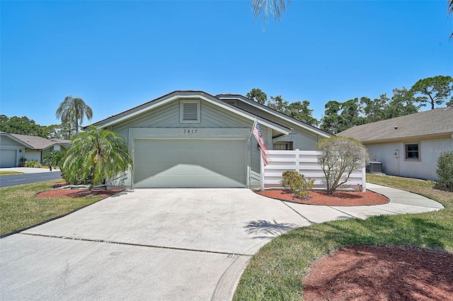 7817 Pine Trace Dr Unit 15, Sarasota, FL 34243 - ranch-style house featuring concrete driveway, an attached garage, fence, and central air condition unit