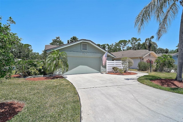 7817 Pine Trace Dr Unit 15, Sarasota, FL 34243 - ranch-style house with a garage, fence, driveway, and a front yard
