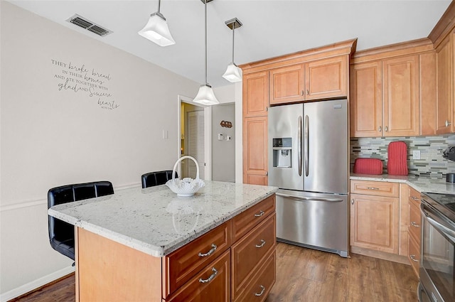 7817 Pine Trace Dr Unit 15, Sarasota, FL 34243 - kitchen featuring visible vents, tasteful backsplash, light stone counters, dark wood-style floors, and stainless steel appliances
