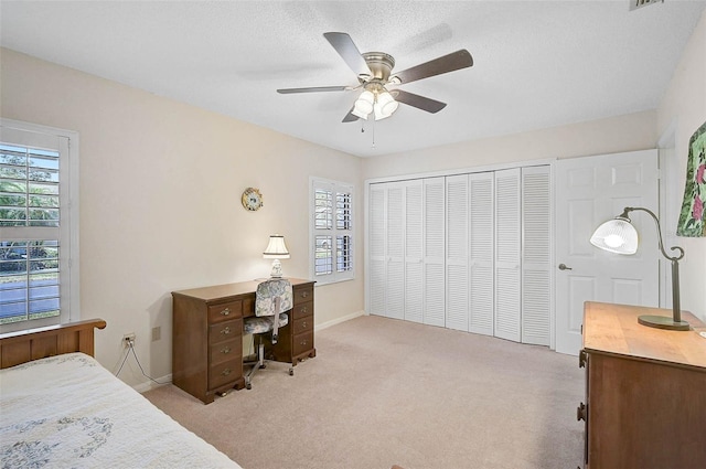 7817 Pine Trace Dr Unit 15, Sarasota, FL 34243 - bedroom with a closet, baseboards, multiple windows, and light carpet