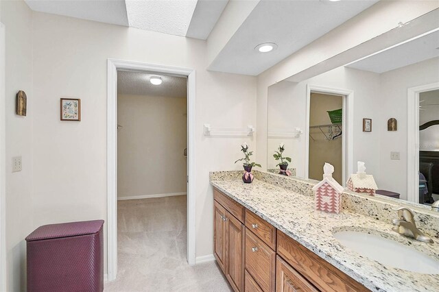 7817 Pine Trace Dr Unit 15, Sarasota, FL 34243 - full bathroom with vanity, baseboards, and a spacious closet