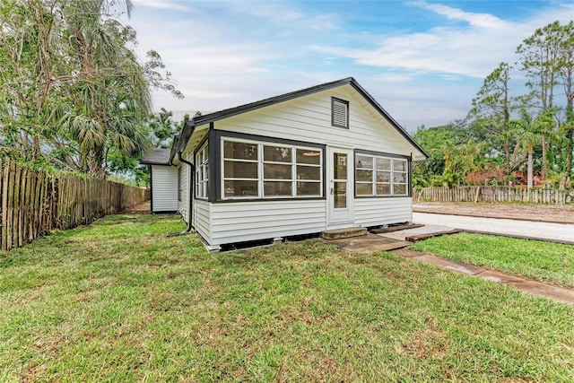 1016 38th St W, Bradenton, FL 34205 - back of house featuring a lawn and fence