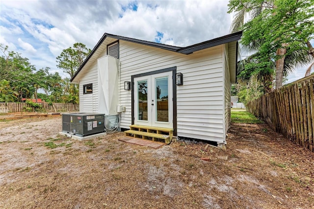 1016 38th St W, Bradenton, FL 34205 - rear view of house with central air condition unit, fence, french doors, and entry steps