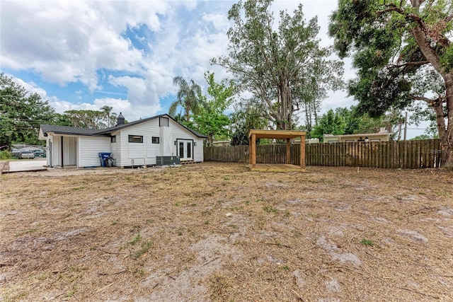 1016 38th St W, Bradenton, FL 34205 - view of yard featuring french doors, fence private yard, and central AC unit