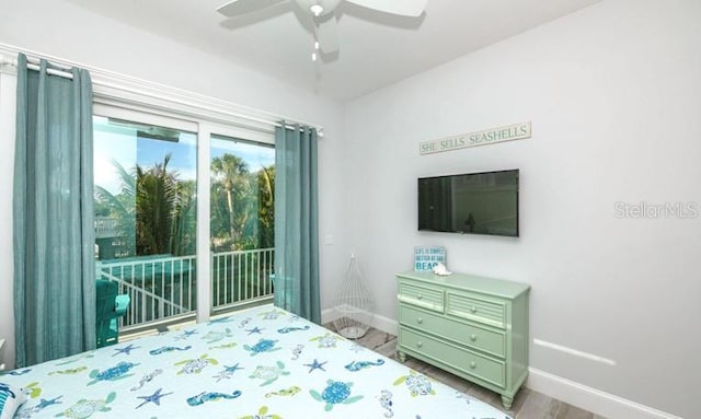 bedroom with access to exterior, baseboards, wood finished floors, and a ceiling fan