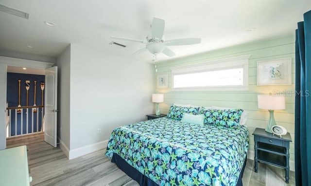 bedroom with baseboards, wood finished floors, and ceiling fan