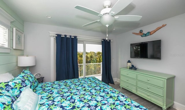 bedroom featuring access to exterior, baseboards, a ceiling fan, and wood finished floors