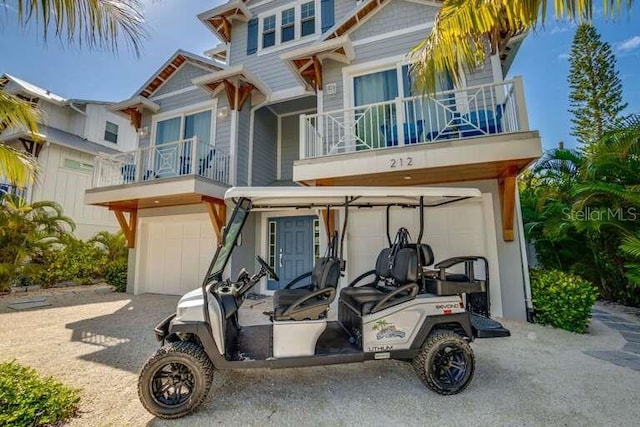 view of front of home featuring a balcony, a garage, and driveway