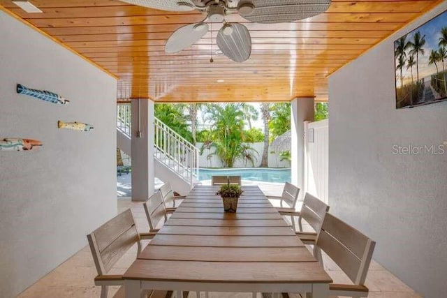 dining area with wooden ceiling, ceiling fan, and a wall of windows