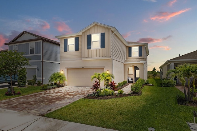 11430 Gallatin Trl, Parrish, FL 34219 - view of front facade with board and batten siding, a garage, decorative driveway, and a front lawn
