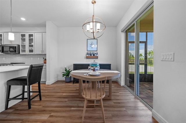 11430 Gallatin Trl, Parrish, FL 34219 - dining area with baseboards, wood finished floors, a chandelier, and recessed lighting