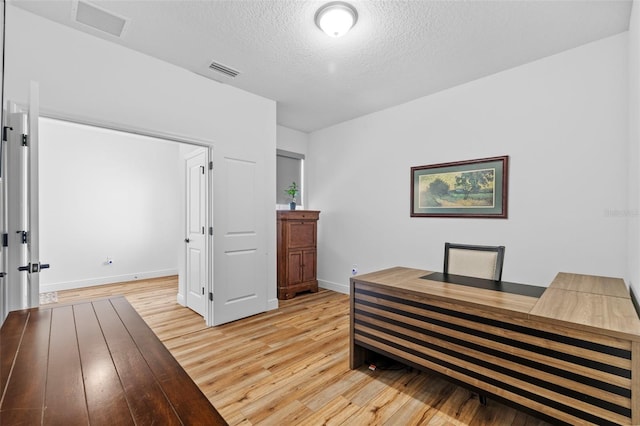 11430 Gallatin Trl, Parrish, FL 34219 - office space with light wood-type flooring, a textured ceiling, and baseboards