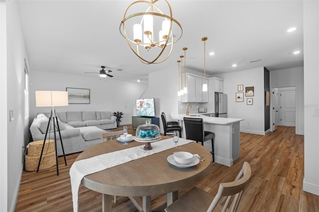 11430 Gallatin Trl, Parrish, FL 34219 - dining area with a ceiling fan, recessed lighting, light wood finished floors, a chandelier, and baseboards
