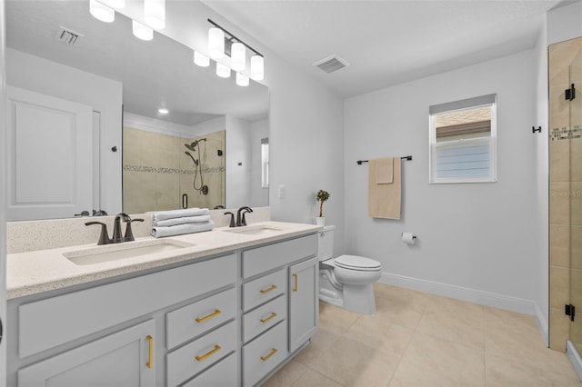 11430 Gallatin Trl, Parrish, FL 34219 - bathroom featuring a shower stall, baseboards, toilet, double vanity, and tile patterned floors