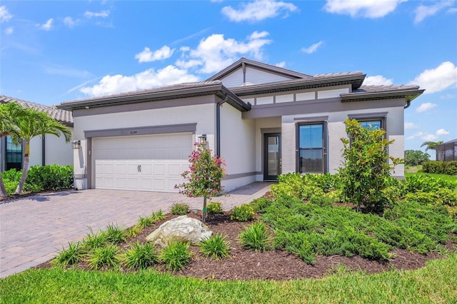 6244 Talon Preserve Dr, Nokomis, FL 34275 - view of front of house with an attached garage, stucco siding, and decorative driveway