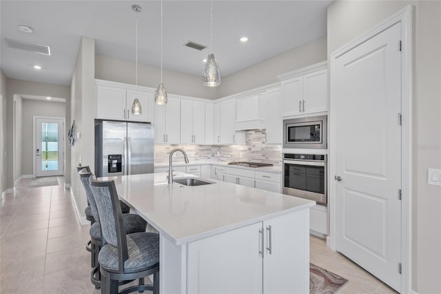 6244 Talon Preserve Dr, Nokomis, FL 34275 - kitchen featuring appliances with stainless steel finishes, a breakfast bar, a sink, decorative backsplash, and visible vents