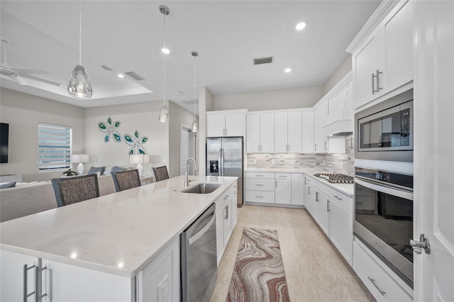 6244 Talon Preserve Dr, Nokomis, FL 34275 - kitchen featuring decorative backsplash, visible vents, appliances with stainless steel finishes, a sink, and open floor plan