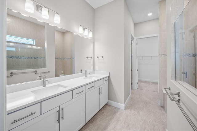 6244 Talon Preserve Dr, Nokomis, FL 34275 - bathroom featuring double vanity, a walk in closet, tiled shower, and a sink