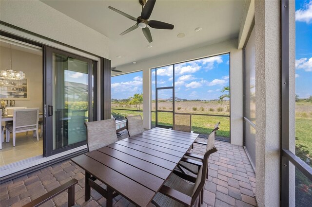 6244 Talon Preserve Dr, Nokomis, FL 34275 - sunroom featuring plenty of natural light, ceiling fan with notable chandelier, and outdoor dining area