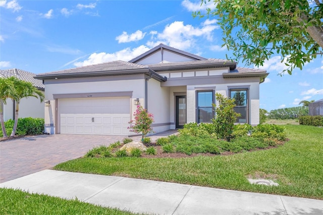 6244 Talon Preserve Dr, Nokomis, FL 34275 - view of front of home with a front lawn, an attached garage, stucco siding, and decorative driveway