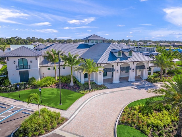 6244 Talon Preserve Dr, Nokomis, FL 34275 - mediterranean / spanish-style house with stucco siding, a standing seam roof, and metal roof