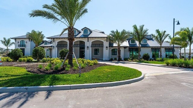 6244 Talon Preserve Dr, Nokomis, FL 34275 - mediterranean / spanish-style home with a front lawn and stucco siding