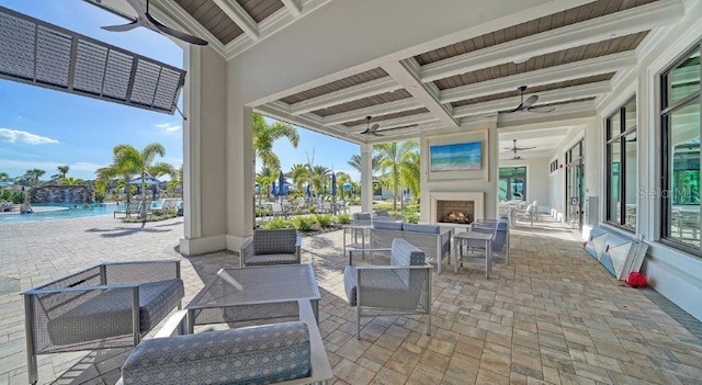 6244 Talon Preserve Dr, Nokomis, FL 34275 - view of patio with a community pool, a ceiling fan, and an outdoor living space with a fireplace