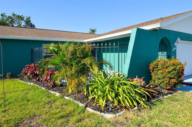 2402 16th St W, Palmetto, FL 34221 - view of home's exterior with an attached garage, a lawn, and roof with shingles