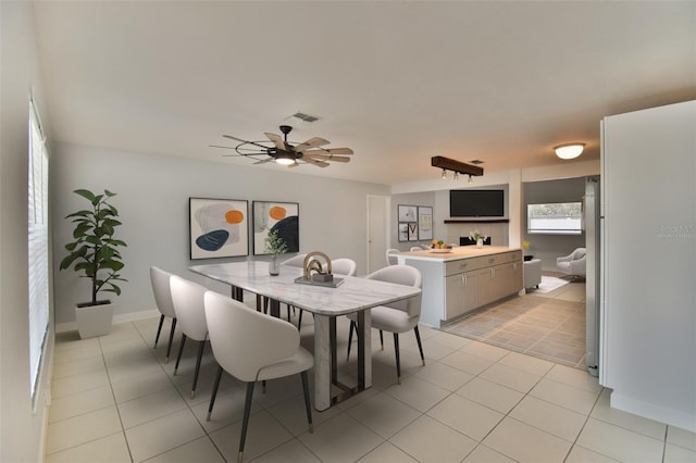 2402 16th St W, Palmetto, FL 34221 - dining room featuring light tile patterned floors, a ceiling fan, and baseboards