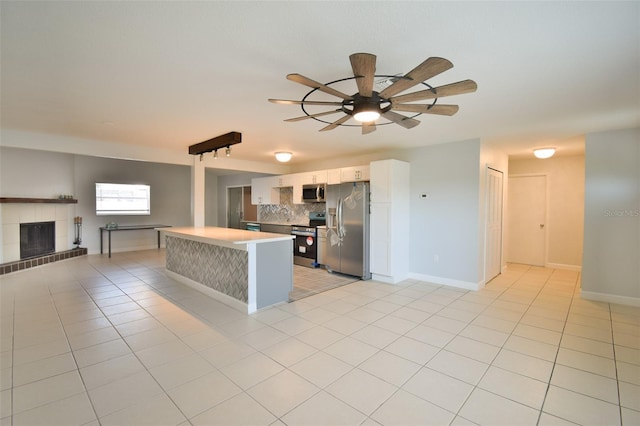2402 16th St W, Palmetto, FL 34221 - kitchen featuring stainless steel appliances, decorative backsplash, white cabinets, a ceiling fan, and light countertops