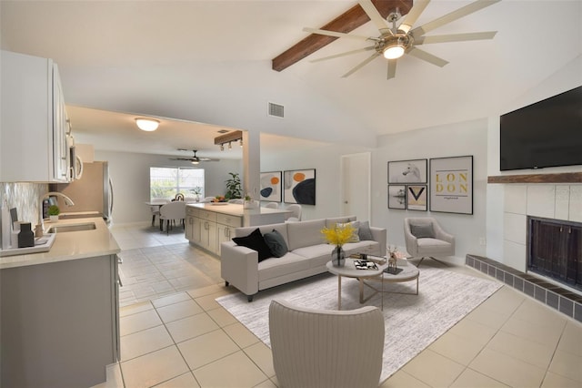 2402 16th St W, Palmetto, FL 34221 - living room with a ceiling fan, light tile patterned floors, and a tiled fireplace