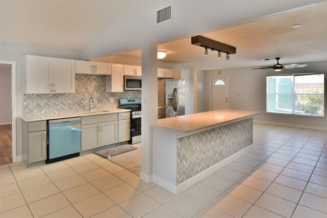 2402 16th St W, Palmetto, FL 34221 - kitchen featuring appliances with stainless steel finishes, a sink, light countertops, backsplash, and a ceiling fan