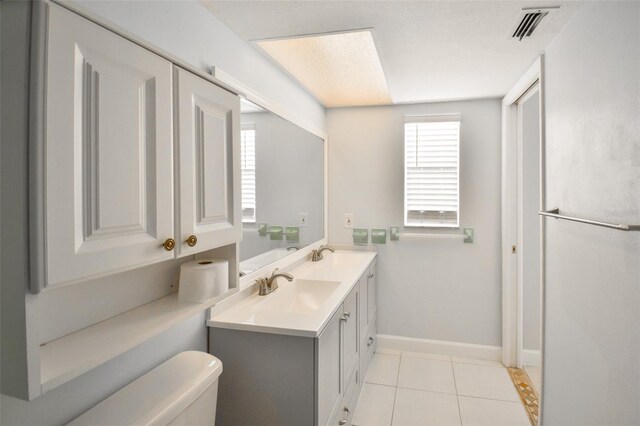 2402 16th St W, Palmetto, FL 34221 - full bathroom featuring toilet, baseboards, tile patterned flooring, and double vanity